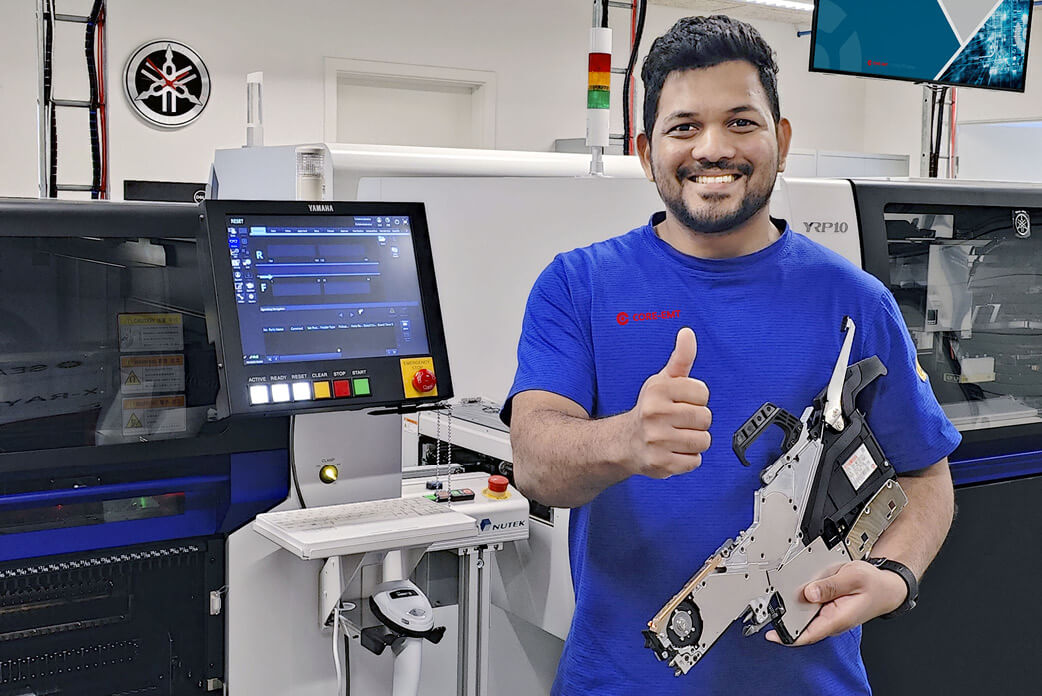 Feeder repair specialist holding a SMT feeder