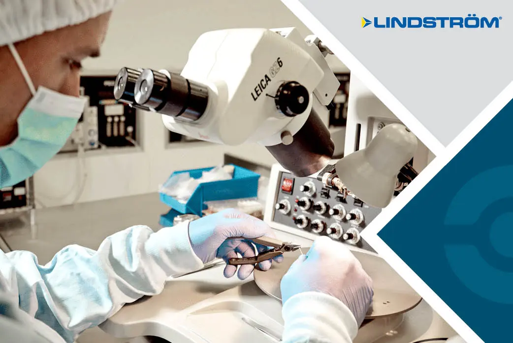 Technician working with a Lindström cutter under a microscope
