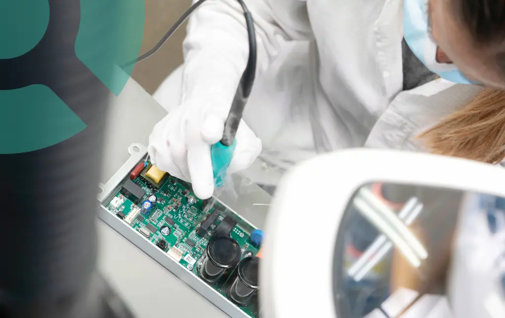 Woman performing PCB rework using an soldring iron
